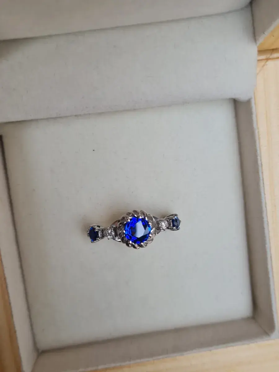 Three-stone royal blue sapphire and diamond ring in white gold